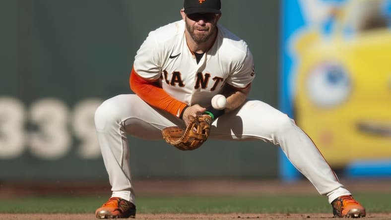 Oct 2, 2022; San Francisco, California, USA; San Francisco Giants third baseman Evan Longoria (10) cannot handle a sharp grounder by Arizona Diamondbacks first baseman Christian Walker during the tenth inning at Oracle Park. Mandatory Credit: D. Ross Cameron-USA TODAY Sports