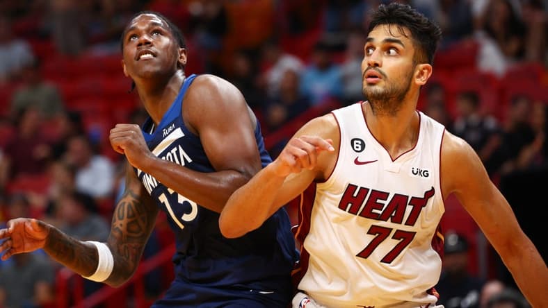 Oct 4, 2022; Miami, Florida, USA;  Miami Heat center Omer Yurtseven (77) and Minnesota Timberwolves forward Nathan Knight (13) fight for a rebound in the fourth quarter during preseason at FTX Arena. Mandatory Credit: Nathan Ray Seebeck-USA TODAY Sports