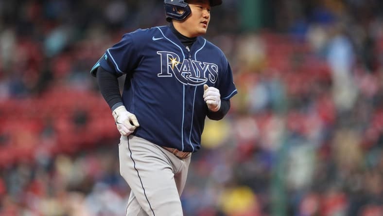 Oct 5, 2022; Boston, Massachusetts, USA; Tampa Bay Rays first baseman Ji-Man Choi (26) hits a home run during the third inning against the Boston Red Sox at Fenway Park. Mandatory Credit: Paul Rutherford-USA TODAY Sports