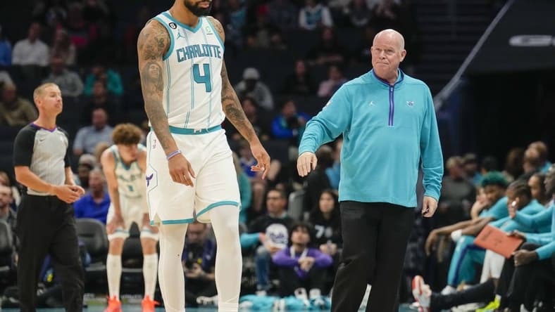 Oct 10, 2022; Charlotte, North Carolina, USA; Charlotte Hornets head coach Steve Clifford fist bumps center Nick Richards (4) after his fourth foul during the second half against the Washington Wizards at Spectrum Center. Mandatory Credit: Jim Dedmon-USA TODAY Sports