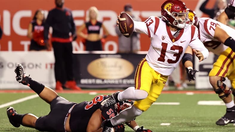 Oct 15, 2022; Salt Lake City, Utah, USA; USC Trojans quarterback Caleb Williams (13) breaks a tackle by Utah Utes defensive tackle Junior Tafuna (58) in the second quarter at Rice-Eccles Stadium. Mandatory Credit: Rob Gray-USA TODAY Sports
