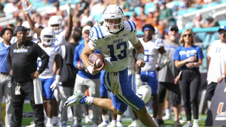 Oct 22, 2022; Miami Gardens, Florida, USA; Duke Blue Devils quarterback Riley Leonard (13) runs with the football for a touchdown during the fourth quarter against the Miami Hurricanes at Hard Rock Stadium. Mandatory Credit: Sam Navarro-USA TODAY Sports