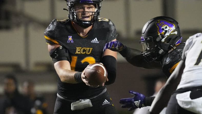 Oct 22, 2022; Greenville, North Carolina, USA; East Carolina Pirates quarterback Holton Ahlers (12) gets ready too hand the ball off against the UCF Knights during the second half at Dowdy-Ficklen Stadium. Mandatory Credit: James Guillory-USA TODAY Sports