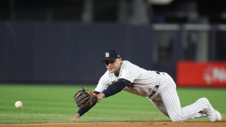 Oct 23, 2022; Bronx, New York, USA; New York Yankees shortstop Isiah Kiner-Falefa (12) dives for the ball in the first inning against the Houston Astros during game four of the ALCS for the 2022 MLB Playoffs at Yankee Stadium. Mandatory Credit: Wendell Cruz-USA TODAY Sports