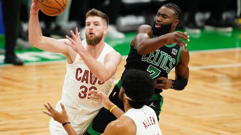 Oct 28, 2022; Boston, Massachusetts, USA; Cleveland Cavaliers forward Dean Wade (32) grabs the rebound against Boston Celtics guard Jaylen Brown (7) in the first quarter at TD Garden. Mandatory Credit: David Butler II-USA TODAY Sports