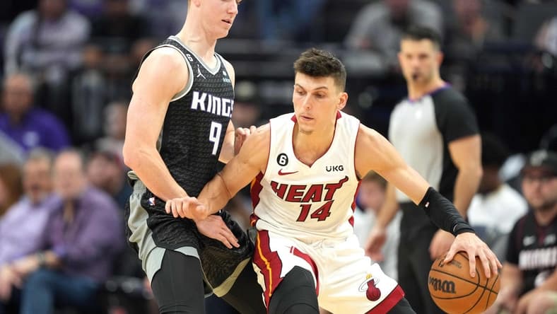 Oct 29, 2022; Sacramento, California, USA; Miami Heat guard Tyler Herro (14) dribbles the ball against Sacramento Kings guard Kevin Huerter (9) during the third quarter at Golden 1 Center. Mandatory Credit: Darren Yamashita-USA TODAY Sports