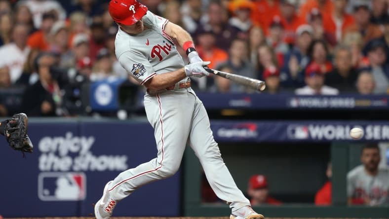 Oct 29, 2022; Houston, Texas, USA; Philadelphia Phillies catcher J.T. Realmuto (10) hits a single during the eighth inning against the Houston Astros in game two of the 2022 World Series at Minute Maid Park. Mandatory Credit: Thomas Shea-USA TODAY Sports