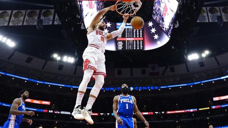 Oct 29, 2022; Chicago, Illinois, USA; Chicago Bulls guard Zach LaVine (8) dunks the ball as Philadelphia 76ers guard James Harden (1) stands nearby during the second half at United Center. Mandatory Credit: David Banks-USA TODAY Sports