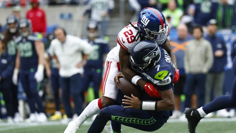 Oct 30, 2022; Seattle, Washington, USA; New York Giants safety Xavier McKinney (29) sacks Seattle Seahawks quarterback Geno Smith (7)  during the second quarter at Lumen Field. Mandatory Credit: Joe Nicholson-USA TODAY Sports