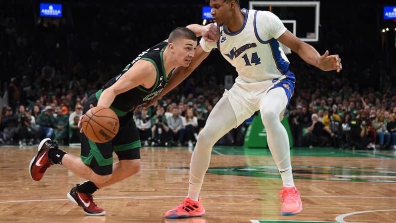 Oct 30, 2022; Boston, Massachusetts, USA; Boston Celtics guard Payton Pritchard (11) controls the ball while Washington Wizards forward Isaiah Todd (14) defends during the second half at TD Garden. Mandatory Credit: Bob DeChiara-USA TODAY Sports