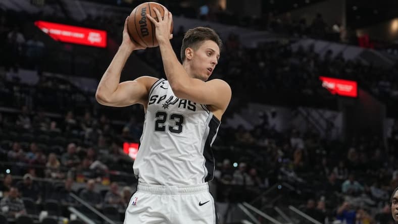 Oct 30, 2022; San Antonio, Texas, USA; San Antonio Spurs forward Zach Collins (23) rebounds in the second half against the Minnesota Timberwolves at the AT&T Center. Mandatory Credit: Daniel Dunn-USA TODAY Sports