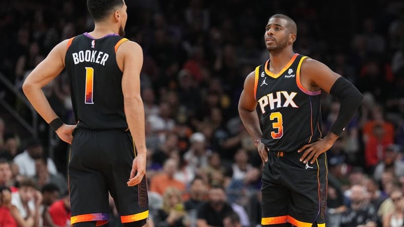 Oct 30, 2022; Phoenix, Arizona, USA; Phoenix Suns guard Devin Booker (1) and Phoenix Suns guard Chris Paul (3) look on against the Houston Rockets during the first half at Footprint Center. Mandatory Credit: Joe Camporeale-USA TODAY Sports