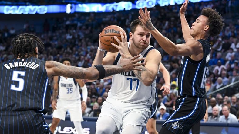 Oct 30, 2022; Dallas, Texas, USA; Orlando Magic guard R.J. Hampton (13) and forward Paolo Banchero (5) defend against Dallas Mavericks guard Luka Doncic (77) during the second half at the American Airlines Center. Mandatory Credit: Jerome Miron-USA TODAY Sports
