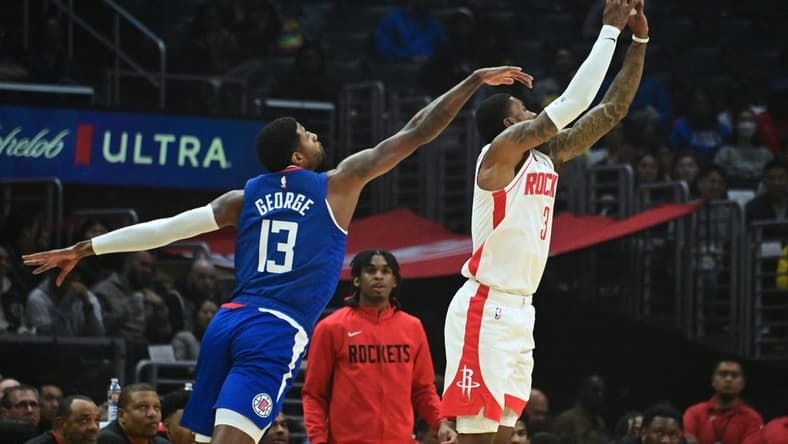 Oct 31, 2022; Los Angeles, California, USA; Houston Rockets guard Kevin Porter Jr. (3) shoots the ball defended by LA Clippers guard Paul George (13) in the first half  at Crypto.com Arena. Mandatory Credit: Richard Mackson-USA TODAY Sports
