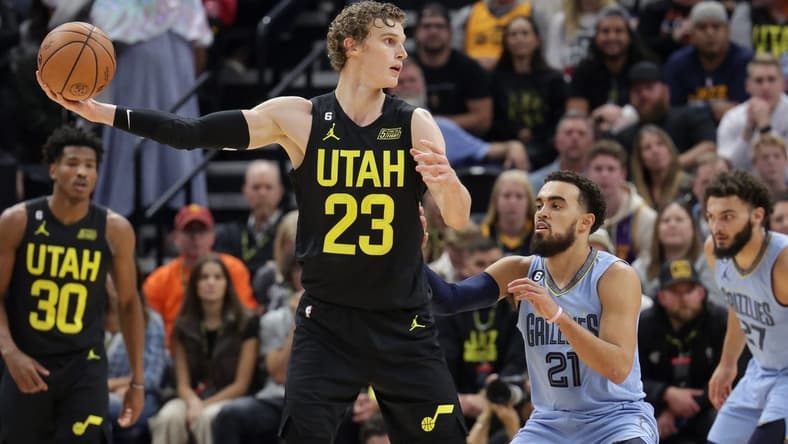 Oct 31, 2022; Salt Lake City, Utah, USA; Utah Jazz forward Lauri Markkanen (23) keeps the ball away from Memphis Grizzlies guard Tyus Jones (21) during the second half at Vivint Arena. Mandatory Credit: Chris Nicoll-USA TODAY Sports