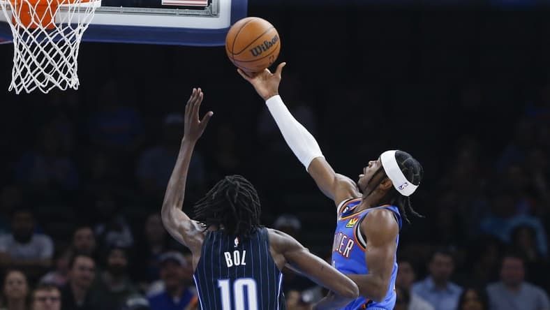 Nov 1, 2022; Oklahoma City, Oklahoma, USA; Oklahoma City Thunder guard Shai Gilgeous-Alexander (2) goes up for a basket as Orlando Magic center Bol Bol (10) defends during the first quarter at Paycom Center. Mandatory Credit: Alonzo Adams-USA TODAY Sports