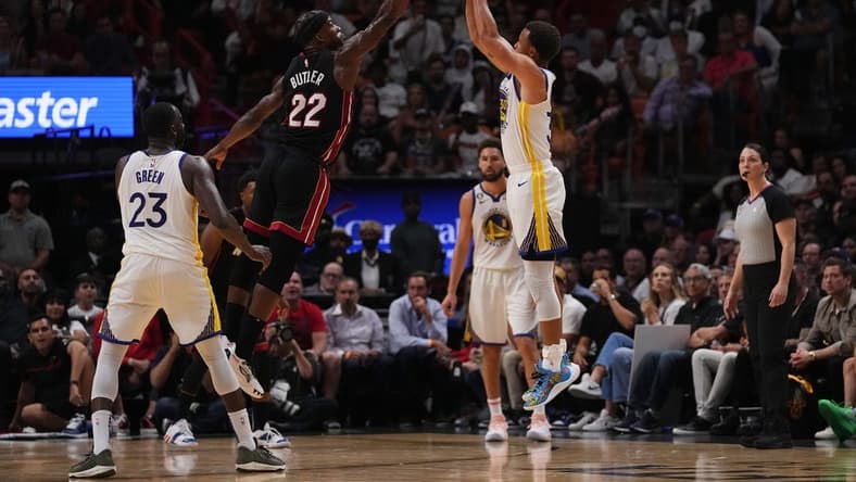 Nov 1, 2022; Miami, Florida, USA; Golden State Warriors guard Stephen Curry (30) attempts a three point shot over Miami Heat forward Jimmy Butler (22) during the second half at FTX Arena. Mandatory Credit: Jasen Vinlove-USA TODAY Sports