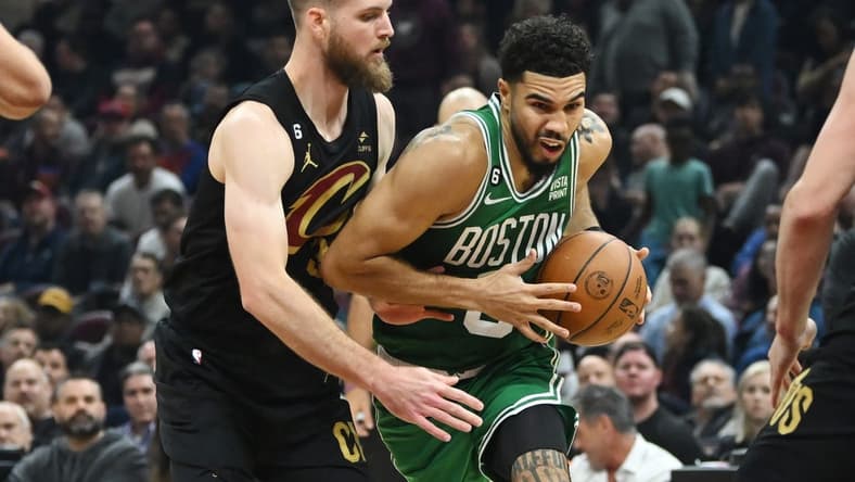 Nov 2, 2022; Cleveland, Ohio, USA; Boston Celtics forward Jayson Tatum (0) drives to the basket against Cleveland Cavaliers forward Dean Wade (32) during the first half at Rocket Mortgage FieldHouse. Mandatory Credit: Ken Blaze-USA TODAY Sports