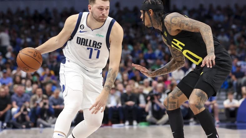 Nov 2, 2022; Dallas, Texas, USA; Dallas Mavericks guard Luka Doncic (77) controls the ball as Utah Jazz guard Jordan Clarkson (00) defends during the second quarter at American Airlines Center. Mandatory Credit: Kevin Jairaj-USA TODAY Sports