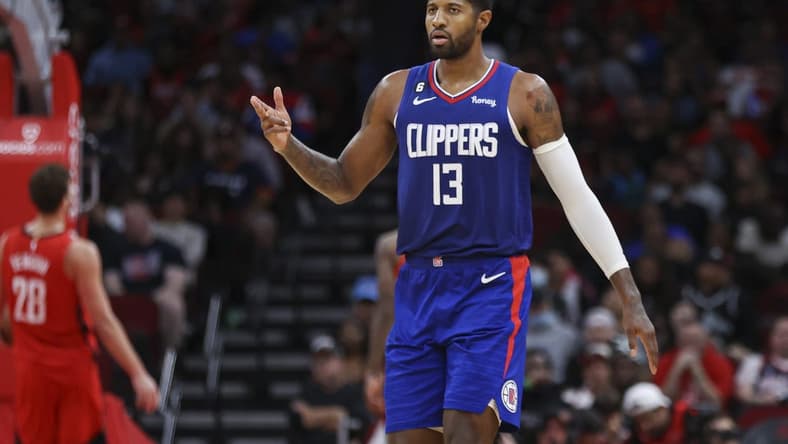 Nov 2, 2022; Houston, Texas, USA; Los Angeles Clippers guard Paul George (13) reacts after a basket by forward Marcus Morris Sr. (not pictured) during the fourth quarter against the Houston Rockets at Toyota Center. Mandatory Credit: Troy Taormina-USA TODAY Sports