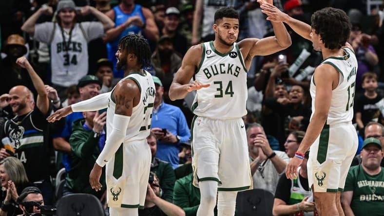 Nov 2, 2022; Milwaukee, Wisconsin, USA; Milwaukee Bucks forward Giannis Antetokounmpo (34) celebrates with forward Jordan Nwora (13) after scoring a basket in the third quarter against the Detroit Pistons at Fiserv Forum. Mandatory Credit: Benny Sieu-USA TODAY Sports