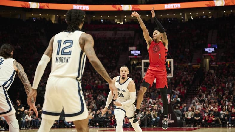 Nov 2, 2022; Portland, Oregon, USA; Portland Trail Blazers guard Anfernee Simons (1) shoots a three point shot against Memphis Grizzlies forward Dillon Brooks (24) during the first half at Moda Center. Mandatory Credit: Troy Wayrynen-USA TODAY Sports
