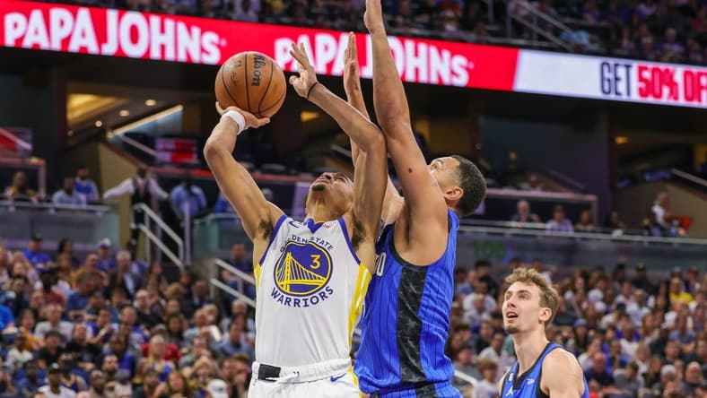 Nov 3, 2022; Orlando, Florida, USA; Golden State Warriors center James Wiseman (33) goes to the basket in front of Orlando Magic guard Jalen Suggs (4) during the second quarter at Amway Center. Mandatory Credit: Mike Watters-USA TODAY Sports