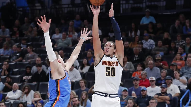 Nov 3, 2022; Oklahoma City, Oklahoma, USA; Denver Nuggets forward Aaron Gordon (50) is defended by Oklahoma City Thunder center Mike Muscala (33) on a three point shot during the second quarter at Paycom Center. Mandatory Credit: Alonzo Adams-USA TODAY Sports