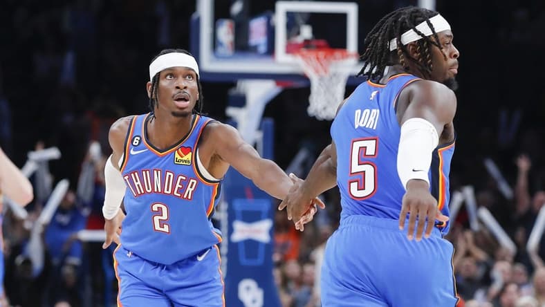 Nov 3, 2022; Oklahoma City, Oklahoma, USA; Oklahoma City Thunder guard Shai Gilgeous-Alexander (2) and Oklahoma City Thunder forward Luguentz Dort (5) high five following a basket against the Denver Nuggets during the second half at Paycom Center. Denver won 122-110. Mandatory Credit: Alonzo Adams-USA TODAY Sports