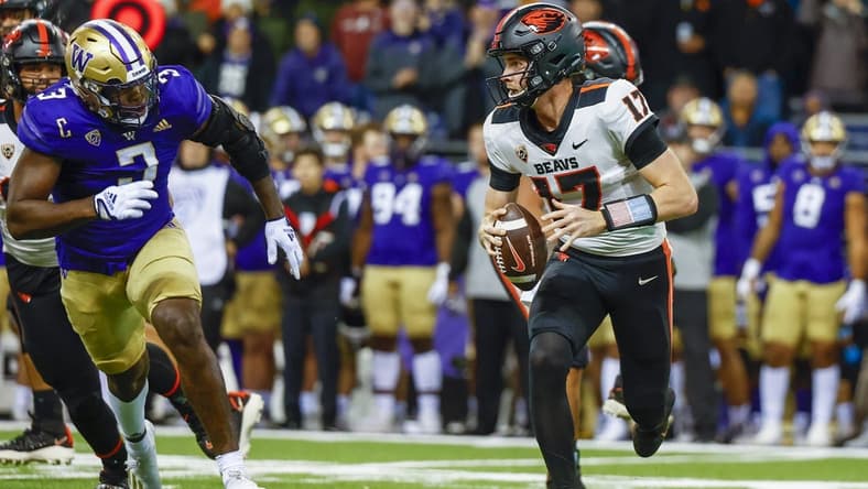 Nov 4, 2022; Seattle, Washington, USA; Oregon State Beavers quarterback Ben Gulbranson (17) scrambles away from Washington Huskies defensive lineman Jeremiah Martin (3) during the first quarter at Alaska Airlines Field at Husky Stadium. Mandatory Credit: Joe Nicholson-USA TODAY Sports