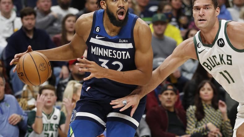 Nov 4, 2022; Minneapolis, Minnesota, USA; Minnesota Timberwolves center Karl-Anthony Towns (32) works around Milwaukee Bucks center Brook Lopez (11) in the third quarter at Target Center. Mandatory Credit: Bruce Kluckhohn-USA TODAY Sports