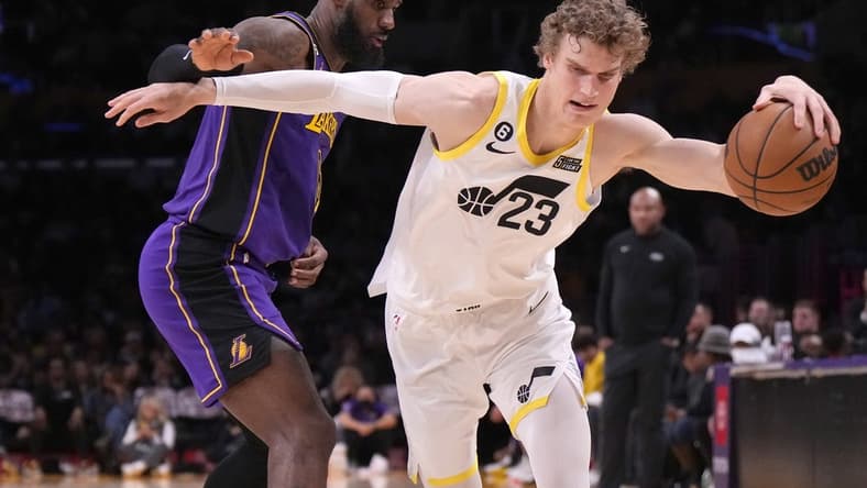 Nov 4, 2022; Los Angeles, California, USA; Utah Jazz forward Lauri Markkanen (23) dribbles the ball against Los Angeles Lakers forward LeBron James (6) in the second half at Crypto.com Arena. Mandatory Credit: Kirby Lee-USA TODAY Sports