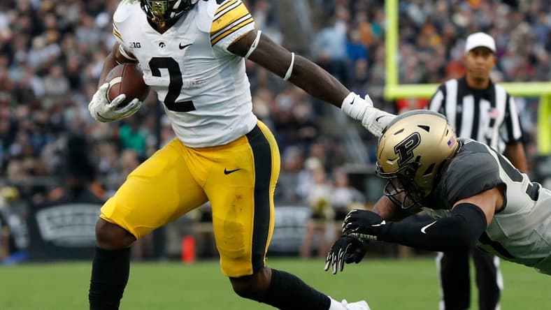 Iowa Hawkeyes running back Kaleb Johnson (2) stiff arms Purdue Boilermakers linebacker Semisi Fakasiieiki (97) during the NCAA football game, Saturday, Nov. 5, 2022, at Ross-Ade Stadium in West Lafayette, Ind.

Purdueiowafb110522 Am30607