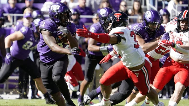 Nov 5, 2022; Fort Worth, Texas, USA; TCU Horned Frogs running back Emari Demercado (3) runs past Texas Tech Red Raiders linebacker Tyrique Matthews (32) during the first half of a game at Amon G. Carter Stadium. Mandatory Credit: Raymond Carlin III-USA TODAY Sports
