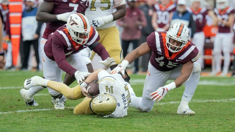 Nov 5, 2022; Blacksburg, Virginia, USA; Virginia Tech Hokies defensive lineman Jaylen Griffin (41) and Virginia Tech Hokies defensive lineman sack Virginia Tech Hokies defensive lineman TyJuan Garbutt (45) sack Georgia Tech Yellow Jackets quarterback Zach Pyron (14) in the firsbhalf at Lane Stadium. Mandatory Credit: Lee Luther Jr.-USA TODAY Sports