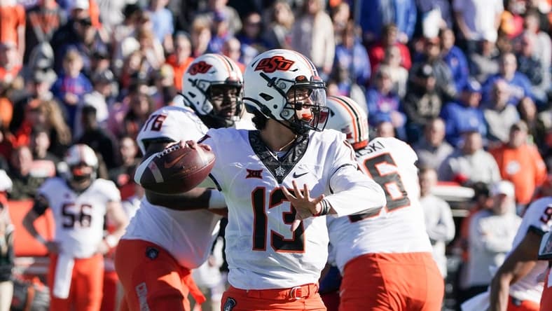 Nov 5, 2022; Lawrence, Kansas, USA; Oklahoma State Cowboys quarterback Garret Rangel (13) throws a pass against the Kansas Jayhawks during the first half of the game at David Booth Kansas Memorial Stadium. Mandatory Credit: Denny Medley-USA TODAY Sports