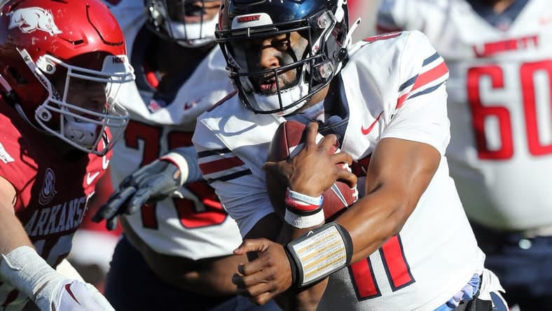 Nov 5, 2022; Fayetteville, Arkansas, USA; Liberty Flames quarterback Johnathan Bennett (11) rushes in the second quarter against the Arkansas Razorbacks at Donald W. Reynolds Razorback Stadium. Mandatory Credit: Nelson Chenault-USA TODAY Sports