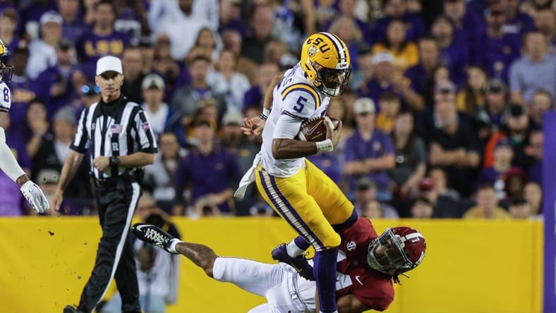 Nov 5, 2022; Baton Rouge, Louisiana, USA; Alabama Crimson Tide defensive back Brian Branch (14) tackles LSU Tigers quarterback Jayden Daniels (5) during the first half at Tiger Stadium. Mandatory Credit: Stephen Lew-USA TODAY Sports