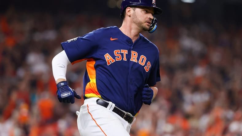 Nov 5, 2022; Houston, Texas, USA; Houston Astros first baseman Trey Mancini (26) runs to first after hitting a single against the Philadelphia Phillies during the third inning in game six of the 2022 World Series at Minute Maid Park. Mandatory Credit: Troy Taormina-USA TODAY Sports