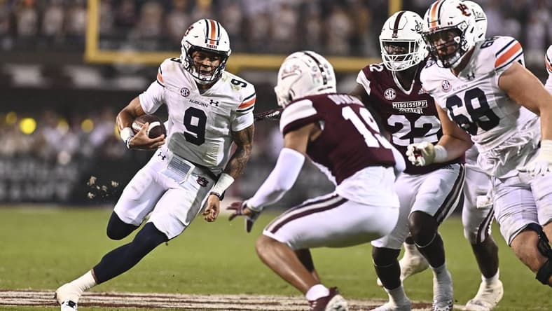 Nov 5, 2022; Starkville, Mississippi, USA; Auburn Tigers quarterback Robby Ashford (9) is defended by Mississippi State Bulldogs safety Collin Duncan (19) during the second quarter at Davis Wade Stadium at Scott Field. Mandatory Credit: Matt Bush-USA TODAY Sports