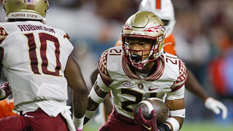 Nov 5, 2022; Miami Gardens, Florida, USA; Florida State Seminoles defensive back Greedy Vance (21) runs with the football after intercepting a pass during the second quarter against the Miami Hurricanes at Hard Rock Stadium. Mandatory Credit: Sam Navarro-USA TODAY Sports
