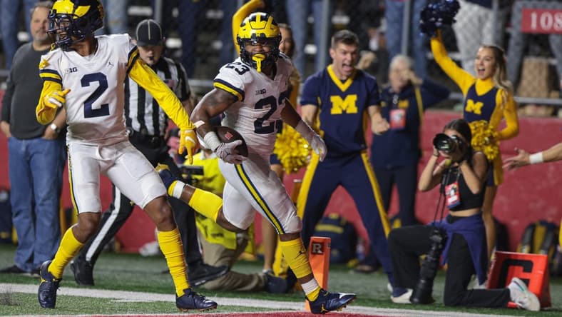 Nov 5, 2022; Piscataway, New Jersey, USA; Michigan Wolverines linebacker Michael Barrett (23) returns an interception for a touchdown during the second half against the Rutgers Scarlet Knights at SHI Stadium. Mandatory Credit: Vincent Carchietta-USA TODAY Sports