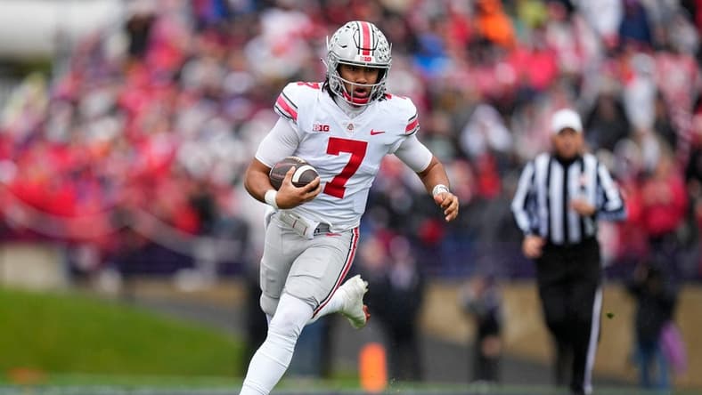 Nov 5, 2022; Evanston, Illinois, USA; Ohio State Buckeyes quarterback C.J. Stroud (7) rushes upfield during the second half of the NCAA football game against the Northwestern Wildcats at Ryan Field. Mandatory Credit: Adam Cairns-The Columbus Dispatch
Ncaa Football Ohio State Buckeyes At Northwestern Wildcats