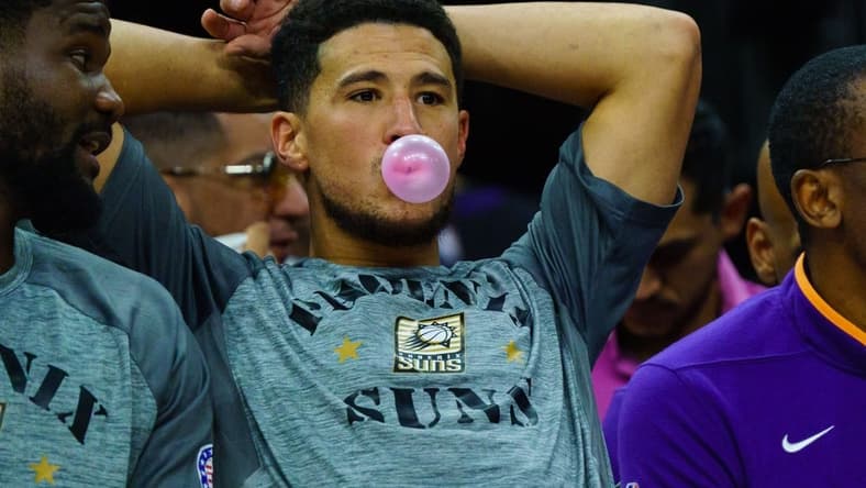 Nov 5, 2022; Phoenix, Arizona, USA; Phoenix Suns guard Devin Booker (1) blows a bubble between plays during the second half against the Portland Trail Blazers at Footprint Center. Mandatory Credit: Allan Henry-USA TODAY Sports