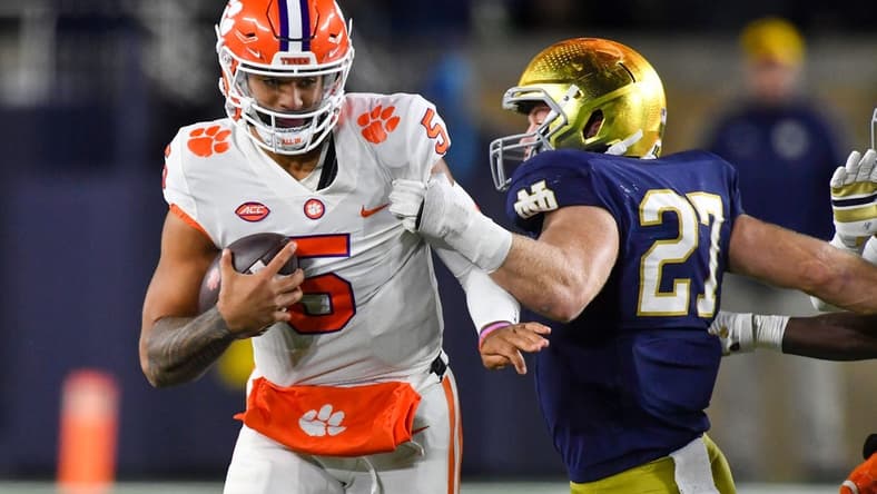 Nov 5, 2022; South Bend, Indiana, USA; Clemson Tigers quarterback DJ Uiagalelei (5) is sacked by Notre Dame Fighting Irish linebacker JD Bertrand (27) in the third quarter at Notre Dame Stadium. Mandatory Credit: Matt Cashore-USA TODAY Sports