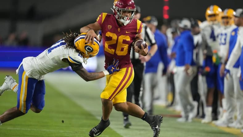 Nov 5, 2022; Los Angeles, California, USA; Southern California Trojans running back Travis Dye (26) is knocked out of bounds by California Golden Bears cornerback Tyson McWilliams (11) in the second half at United Airlines Field at Los Angeles Memorial Coliseum. Mandatory Credit: Kirby Lee-USA TODAY Sports