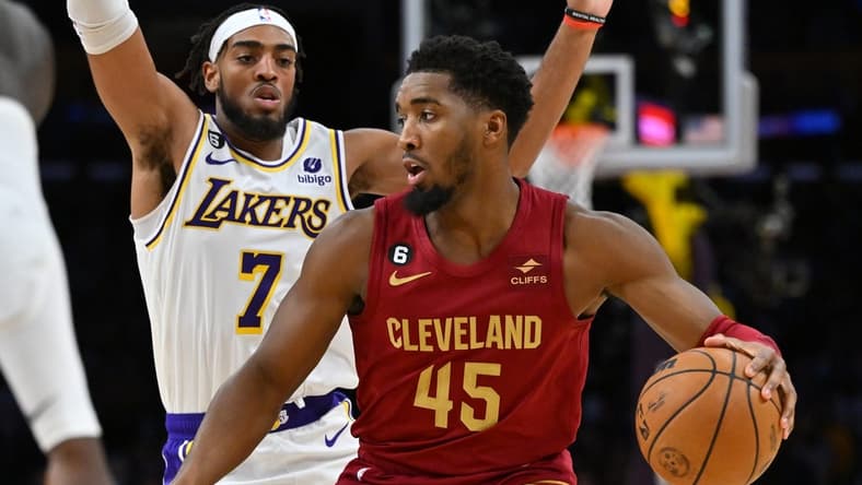 Nov 6, 2022; Los Angeles, California, USA;  Los Angeles Lakers forward Troy Brown Jr. (7) guards Cleveland Cavaliers guard Donovan Mitchell (45) as he drives to the basket in the first half at Crypto.com Arena. Mandatory Credit: Jayne Kamin-Oncea-USA TODAY Sports