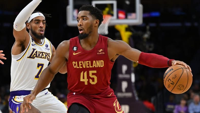 Nov 6, 2022; Los Angeles, California, USA;  Los Angeles Lakers forward Troy Brown Jr. (7) guards Cleveland Cavaliers guard Donovan Mitchell (45) as he drives to the basket in the first half at Crypto.com Arena. Mandatory Credit: Jayne Kamin-Oncea-USA TODAY Sports