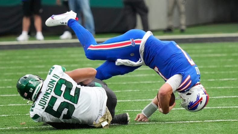 Nov 6, 2022; East Rutherford, NJ, USA;
New York Jets defensive end Jermaine Johnson (52) takes down Buffalo Bills quarterback Josh Allen (17) in the 4th quarter at MetLife Stadium. Mandatory Credit: Robert Deutsch-USA TODAY Sports
