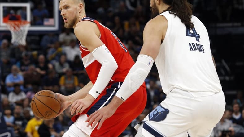 Nov 6, 2022; Memphis, Tennessee, USA; Washington Wizards center Kristaps Porzingis (6) passes the ball as Memphis Grizzlies center Steven Adams (4) defends during the second half at FedExForum. Mandatory Credit: Petre Thomas-USA TODAY Sports